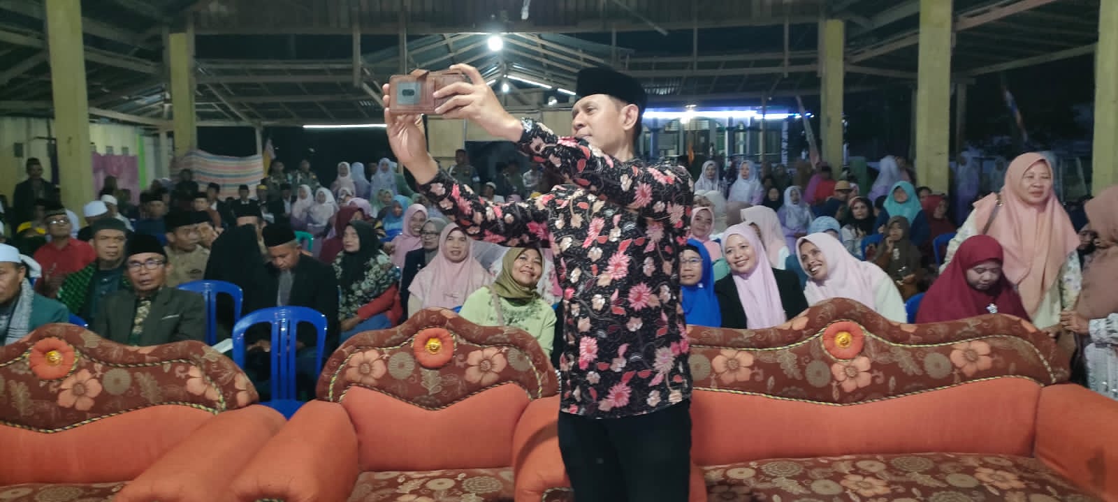 Wabup Bima dr.Irfan Zubaidy berswafoto menggunakan gawai warga saat pembukaan MTQ XI Kec.Parado Bima. (Foto;MDA)